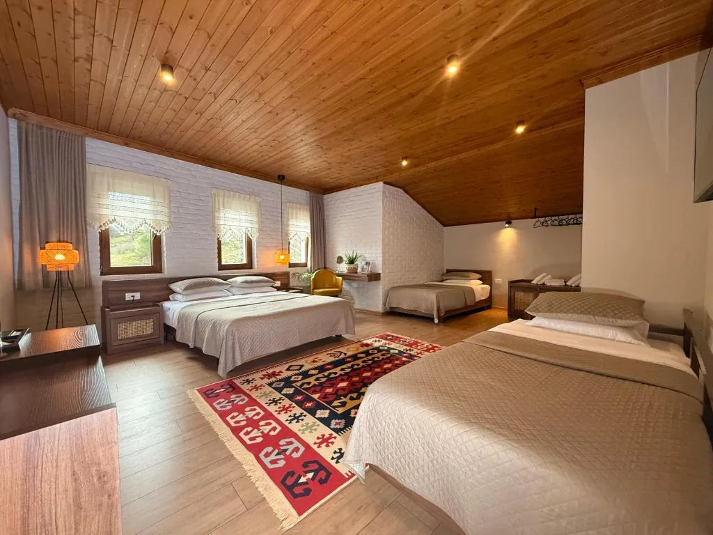 Deluxe Quadruple Room — The Stone Sky Hotel